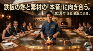 高級感のあるステーキハウスの円形鉄板カウンターで、デニム地のコックコートを着たシェフが、炎を上げながら厚切りステーキを焼き上げる様子。背景にはワインを楽しむ客が並び、画像上部には「鉄板の熱と素材の『本音』に向き合う。漢たちの『後姿』鉄板の流儀。」というキャッチコピーが入っている。